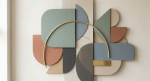 Abstract wall art composed of pastel-colored geometric shapes with a brass arc